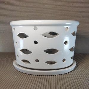 Ceramic plant pot with light slots. On small legs. Glazed inside and outside. A saucer in the set. Set of two pot and saucer.