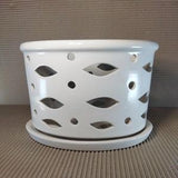Ceramic plant pot with light slots. On small legs. Glazed inside and outside. A saucer in the set. Set of two pot and saucer.