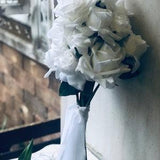 Winter white, open blooms and reflexed winter white rose bouquet and groom buttonhole