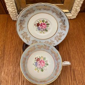 Paragon Warrant Bone China Light Blue Background with Gold Scroll and a Floral Bouquet Cup and Saucer