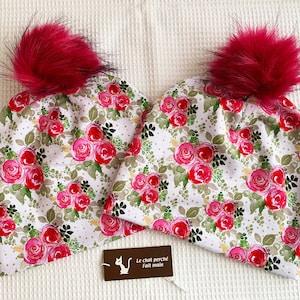 tuque beanie bonnet winter woman jersey cotton lined, white background bouquet pinks fushias, pompom pressure fushia