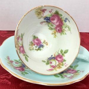 E B Foley turquoise cup and saucer covered in floral bouquets