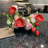 Colorful silk artificial flowers in a hat box with red poppies for home decoration, elegant and delicate modern flowers arrangement.