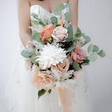 Bridal bouquet with silk flowers and eucalyptus leaves pampas grass, in dusty pink, peach, blush, cream. Boho and rustic wedding bouquet.
