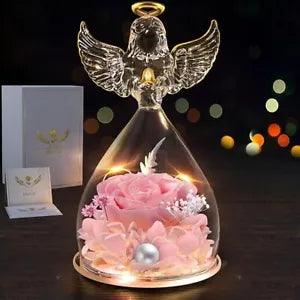 Glass angel figurine with preserved pink rose and glowing LED light under dome