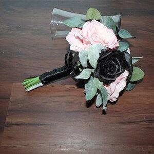 Modern pink and black bridesmaids bouquet, pink peonies and roses. Black roses/calla lilies. Eucalyptus and lamb ear wrapped in black satin.