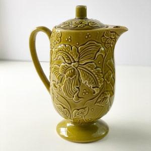 Unique vintage avocado green teapot with floral orchid raised bebossed pattern.