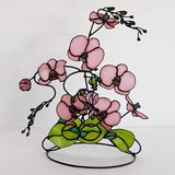 Stained glass orchid, pink glass flower with plant leaves on a metal stand, flower sculpture, consists of several branches, 3D Stained glass