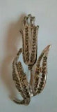 Large Silver Coloured And Dark Gemmed Lily Flower Brooch