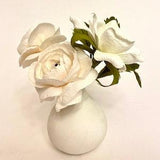 Ranunculus and wild rose arrangement