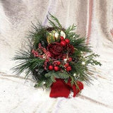 Christmas bouquet with fairy lights and wax rose