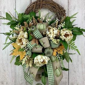 Fall crescent wreath for front door with peonies, fall leaves, berries, pumpkins, outdoor grapevine wreath, neutral colours, bow, elegant