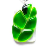 Fused glass pendant of a transparent green leaf