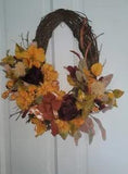 Fall Yellow, orange and burgundy peonies and  mums on an  oval front door wreath