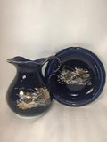 Cobalt blue pitcher and decorative plate set with peacock and floral accents.