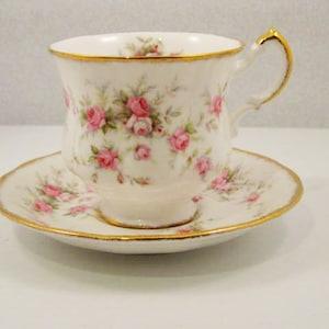 Paragon  "Victoriana  Rose"  Pattern Tea Cup and Saucer.   Paragon Company  Made in England By appointment to HRH The Queen