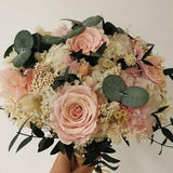 Bridal bouquet of preserved flowers with pink roses and eucalyptus