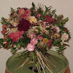 Bouquet of dried flowers with roses, peonies and everlasting flowers