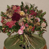 Bouquet of dried flowers with roses, peonies and everlasting flowers