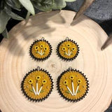 Round leather earrings with quill accents in yellow, black and gold