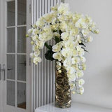 Real touch cream orchid arrangement in a designed metal vase. Faux floral arrangement