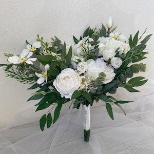 White bridal bouquet of artificial silk flowers in a classic style for the bride and bridesmaid, boho silk bouquet.