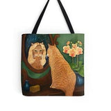 Orange Tabby Cat in Mirror designer fashion tote bag. Ginger Cat in blonde wig and orchids. Colorful and whimsical bag. Washable polyester.