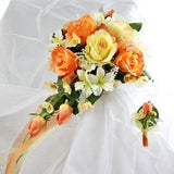 Elegant Cascading Bouquet and Boutonniere for a Classic Romantic Wedding crafted with coral, orange, and yellow roses.