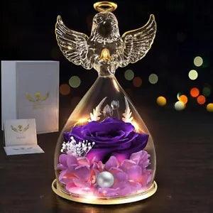 Glass angel figurine with purple preserved rose in glass dome base, glowing LED light