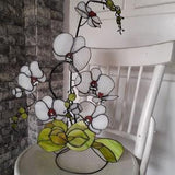 Stained glass orchid, white glass flower with plant leaves on a metal stand, flower sculpture, consists of several branches,3D Stained glass