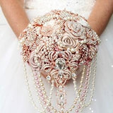 Rose gold brooch bouquet. Dusty rose wedding bouquet. Cascade champagne jeweled bouquet.