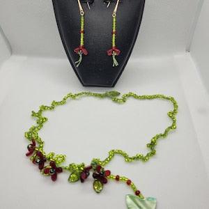 Crochet romantic necklace and earrings set with acrylic flowers, shell butterflies, and seedbeads linked with a silk thread.