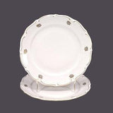 Pair of Walbrzych luncheon or small dinner plates made in Poland. Golden floral bouquet, embossed rim. Flaw (see below).