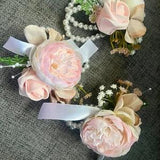 bracelet corsages of pale pink peonies on a pearl bracelet