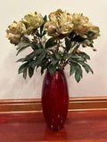 Red vase with faux peonies