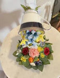 The flying Cup of the blue ribbon spills the beautiful flowers on the plate