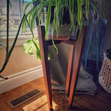 Stylish mid century modern style plant stand with tapered legs and traditional joinery