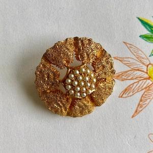 Lovely stylized Gold Flower Brooch with Seed Pearls in the center.
