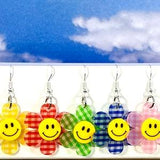 Acrylic flowers with happy faces in the choices of yellow, pink, red, green, blue