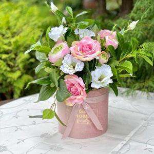 Artificial flowers in a round box, flower arrangement, bouquet. Home decor. Eustoma, rose, ranunculus. Present. Mother's day, birth