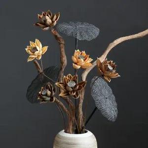 Dried flower arrangement with rattan stems and beige blooms in a white vase