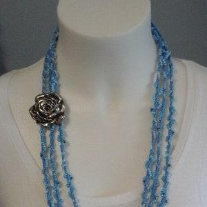 Kumihimo braided necklace for women, embroidered with seed beaded ending. Boho style - light blue color with flower pendant.