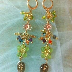 Earrings from the new ??Spring Flower?? collection with pink flowers and pink gold, frosted green and gold flowers and Swarovski crystal