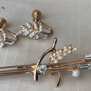 Vintage flower and wishbone brooch and earring set with seed pearls and rhinestones.