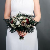 Burgundy and white winter wedding bridal bouquet pine cones real preserved roses and greenery real flowers woodland wedding