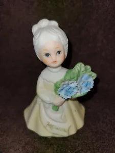 Vintage February Birthday Girl with Flowers Figurine Blue carnations