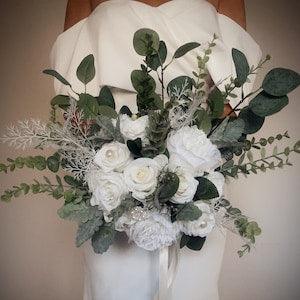 White rose and peony, eucalyptus natural bridal bouquet , green foliage subtle pearl beads and brooch detail , white wedding flowers.