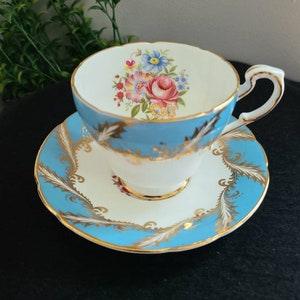 Paragon Fine Bone China England, Vintage Footed Tea Cup and Saucer, Sky Blue Band Gold Scrolls w/ Floral Bouquet Scalloped Edges (E104H)