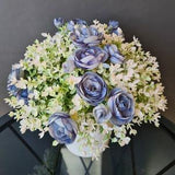 Mini Blue Ranunculus and White Greenery Artificial Bouquet in White Pot by Milda Smilga