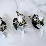 Boutonniere for wedding or prom with white rosebud, baby's breath, greenery